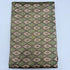 Folded charcoal grey pure silk Ikat fabric featuring alternating olive green and beige geometric diamond motifs with Silk Mark certification