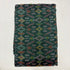 Folded deep forest green pure silk Ikat fabric featuring traditional geometric diamond and rust motifs with Silk Mark certification.