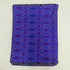 Folded indigo violet pure silk Ikat fabric featuring geometric diamond trellis lattice in plum purple and magenta with Silk Mark certification.