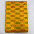 Folded vibrant mustard yellow pure silk Ikat fabric featuring alternating olive green and rust ikat butis with Silk Mark certification