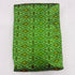 Folded vibrant parrot green pure silk Ikat fabric featuring intricate geometric diamond and olive floral motifs with Silk Mark certification.