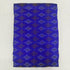 Folded royal blue pure silk Ikat fabric featuring geometric diamond lattice patterns in plum and violet with Silk Mark certification.