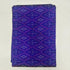 Folded royal blue pure silk Ikat fabric featuring geometric diamond lattice patterns in purple and soft lavender with Silk Mark certificatio