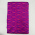 Folded royal purple pure silk Ikat fabric featuring vibrant magenta geometric diamond trellis patterns with Silk Mark certification.