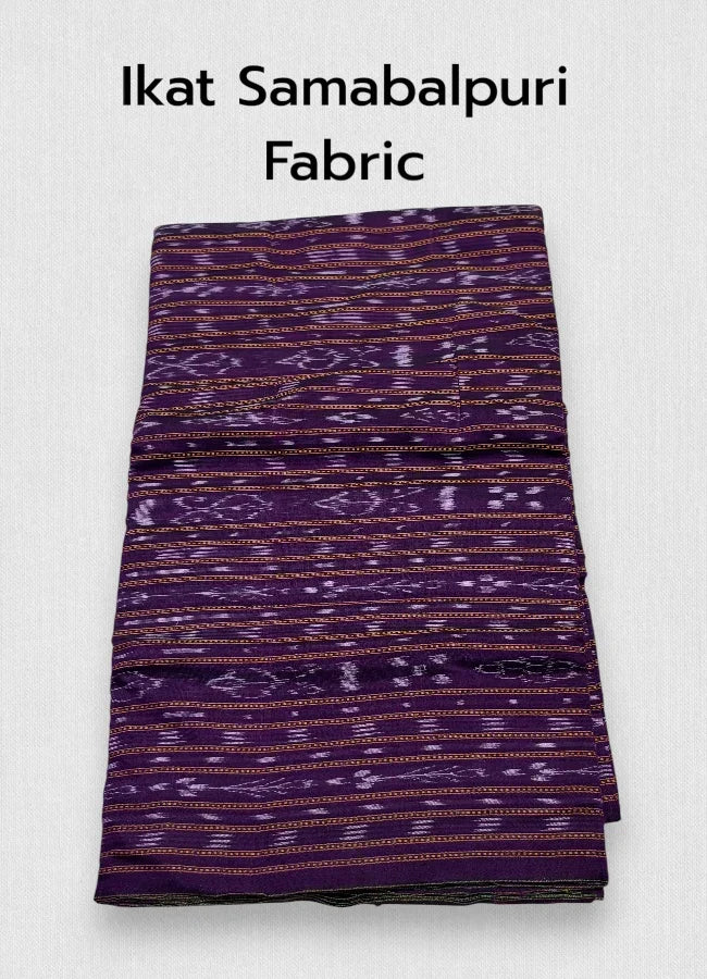 Folded dark purple Sambalpuri Ikat cotton fabric featuring traditional horizontal woven motifs in lavender and orange, displayed on a wooden surface next to artisan wooden blocks.