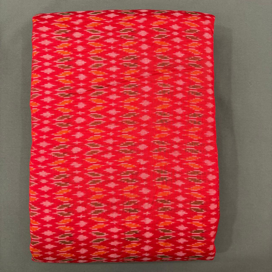 Small geometric vertical patterns tho unna bright red Pochampally ikkat sico unstitched dress material.