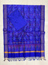 Royal blue Pochampally Ikat silk unstitched dress material set featuring intricate handwoven geometric motifs, a detailed temple pattern border with gold stripes, and matching blue tassels.