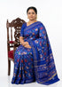 Model wearing a royal blue pure silk Ikkat Patola saree featuring traditional 9 figure navratna motifs and a gold zari border.