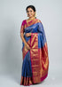 South Indian model wearing a royal blue Dharmavaram silk saree with contrast rani pink gold zari border and pallu