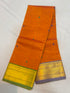 Handloom rust orange pure Kanchi cotton saree with small teal-blue buttas and dual Ganga Jamuna borders in olive green and slate lavender with gold zari