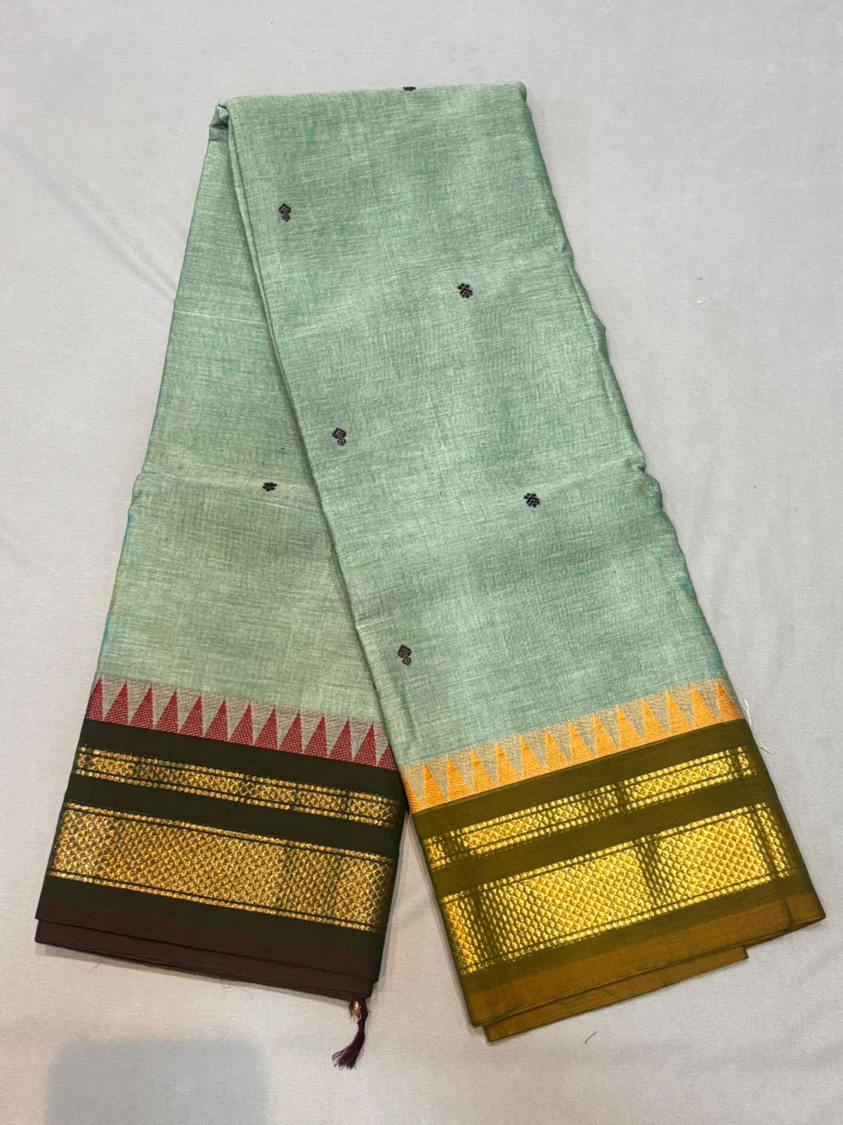 Handloom sea green Kanchi cotton saree with small black floral buttas and dual-tone Ganga Jamuna temple borders with gold zari