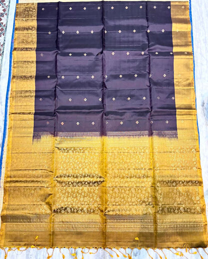 Silk Mark certified midnight purple Kanchi soft silk saree featuring gold zari butis and a heavy gold brocade pallu with tassels