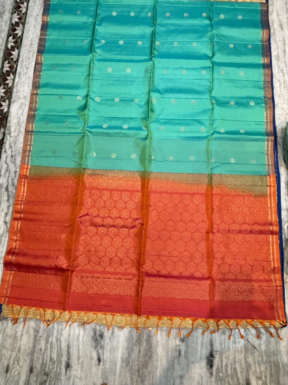 Silk Mark certified sea green Kanchi soft silk saree with gold zari buttas and a contrasting rust orange honeycomb brocade pallu with tassels