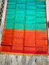 Silk Mark certified sea green Kanchi soft silk saree with gold zari buttas and a contrasting rust orange honeycomb brocade pallu with tassels