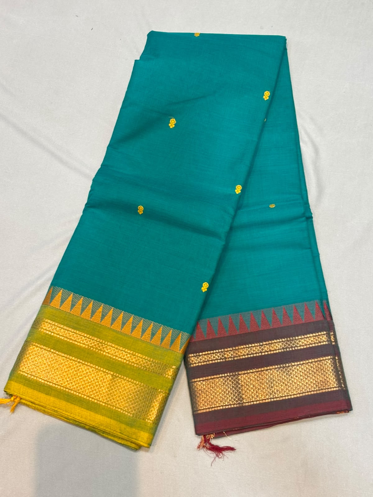 Handloom teal green pure Kanchi cotton saree with yellow floral buttas and Ganga Jamuna temple borders in yellow and wine maroon with gold zari